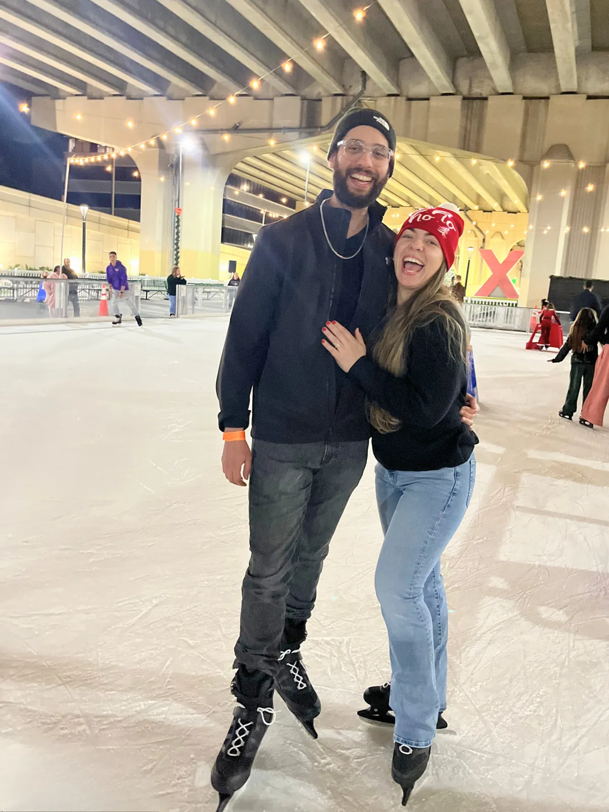 Two people ice skating at the downtown Jacksonville holiday rink