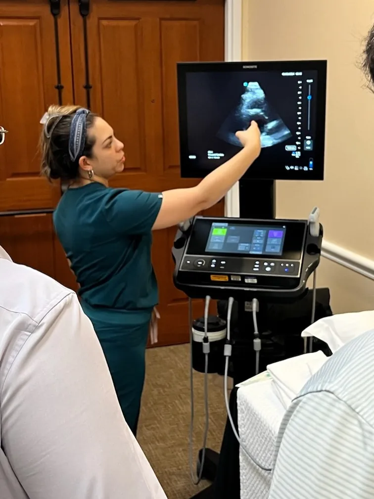 Fellow reviewing a cardiac ultrasound image at the bedside